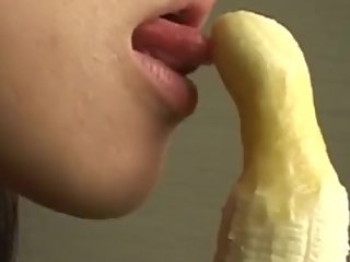 japanese girl sexily eating a banana and shaping it to be dick